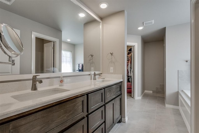 1624 NE 32nd St, Moore, OK 73160 - bathroom featuring double vanity, a bath, tile patterned floors, a walk in closet, and recessed lighting