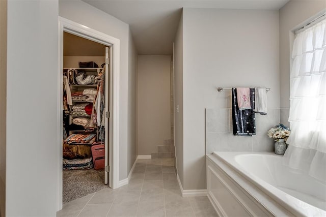 1624 NE 32nd St, Moore, OK 73160 - bathroom featuring a garden tub, a spacious closet, and tile patterned flooring
