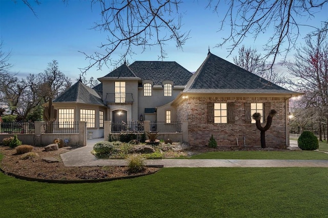 1514 Duxsford Ct, Edmond, OK 73034 - view of front facade featuring a fenced front yard, a balcony, brick siding, and roof with shingles