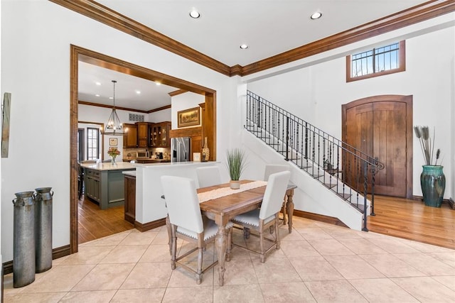 1514 Duxsford Ct, Edmond, OK 73034 - dining area featuring ornamental molding, stairs, light tile patterned flooring, recessed lighting, and a chandelier