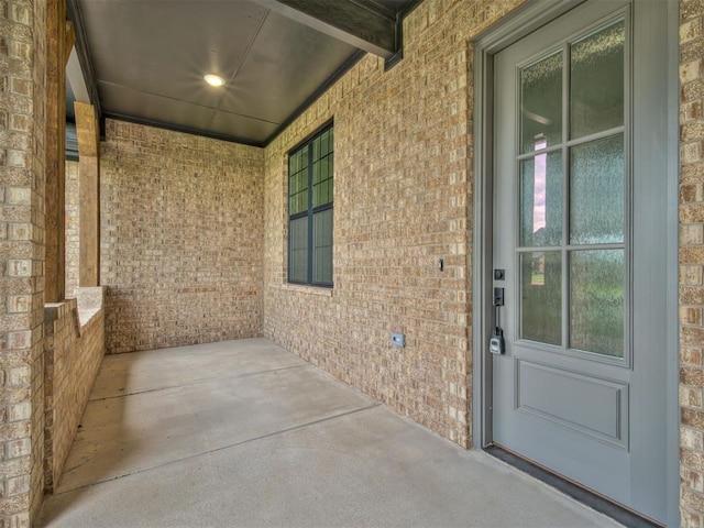 77 Orchid Ct, Piedmont, OK 73078 - view of exterior entry featuring a porch and brick siding