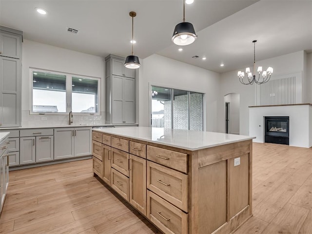 77 Orchid Ct, Piedmont, OK 73078 - kitchen with arched walkways, gray cabinets, light wood-style flooring, healthy amount of natural light, and recessed lighting