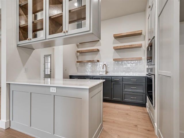 77 Orchid Ct, Piedmont, OK 73078 - kitchen featuring open shelves, a peninsula, light countertops, oven, and gray cabinets