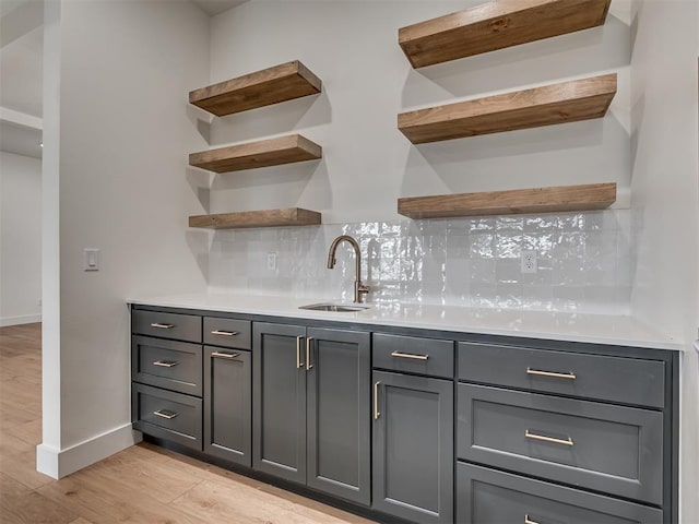 77 Orchid Ct, Piedmont, OK 73078 - indoor wet bar featuring light wood-type flooring and backsplash