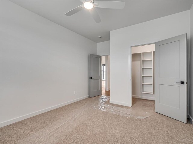 77 Orchid Ct, Piedmont, OK 73078 - unfurnished bedroom with light colored carpet, a spacious closet, a closet, and ceiling fan