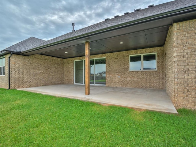 77 Orchid Ct, Piedmont, OK 73078 - rear view of house featuring a patio area, brick siding, and a yard