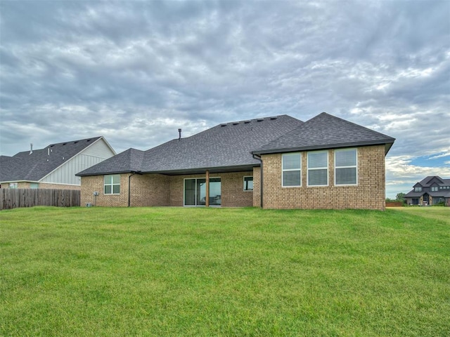 77 Orchid Ct, Piedmont, OK 73078 - rear view of house featuring a shingled roof and brick siding