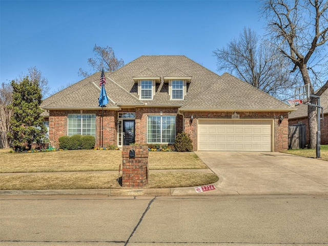 view of front of home featuring brick siding, driveway, roof with shingles, a front yard, and an attached garage