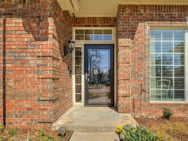 property entrance featuring brick siding