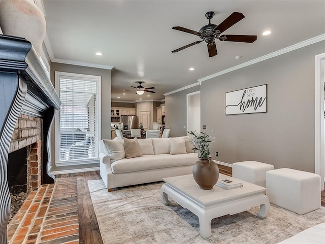 living area featuring ornamental molding, recessed lighting, ceiling fan, and wood finished floors
