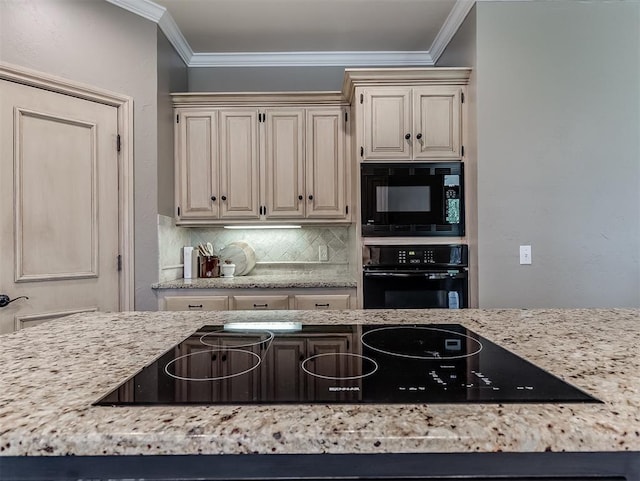 kitchen featuring black appliances, cream cabinetry, crown molding, and backsplash