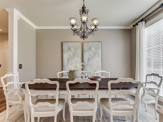 dining area featuring a chandelier, wood finished floors, crown molding, and plenty of natural light
