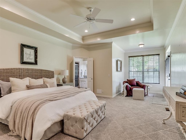 bedroom featuring crown molding, a tray ceiling, light carpet, and baseboards