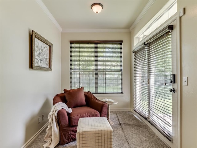 sitting room with baseboards, a healthy amount of sunlight, crown molding, and carpet