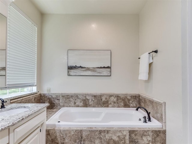 bathroom with vanity and a bath