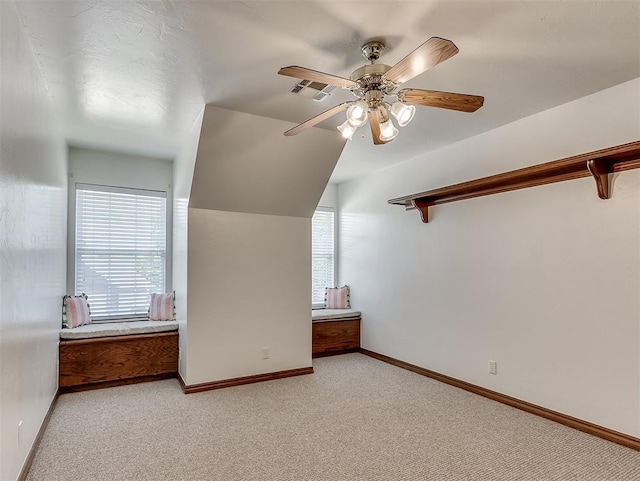 bonus room with visible vents, baseboards, a ceiling fan, and light carpet