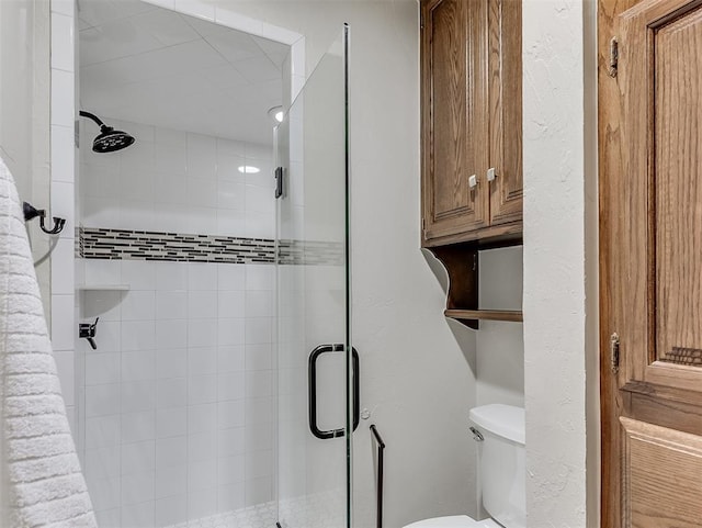 full bathroom with a shower stall and toilet