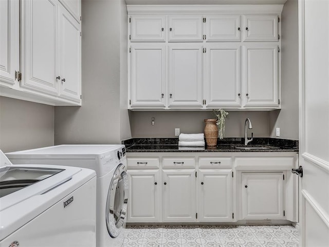 clothes washing area with light tile patterned floors, independent washer and dryer, cabinet space, and a sink