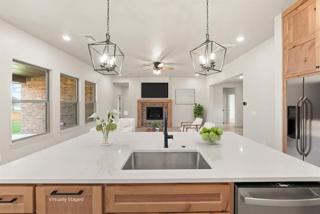 11713 NW 105th St, Yukon, OK 73099 - kitchen with appliances with stainless steel finishes, a sink, a chandelier, open floor plan, and recessed lighting