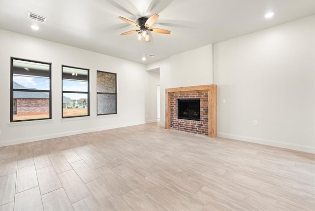 11713 NW 105th St, Yukon, OK 73099 - unfurnished living room with ceiling fan, light wood-style flooring, recessed lighting, a fireplace, and baseboards