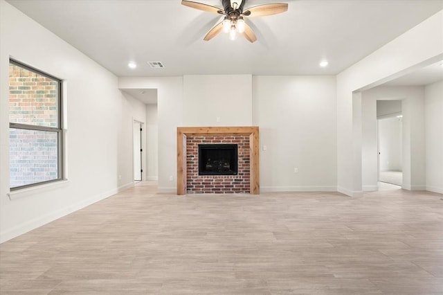 11713 NW 105th St, Yukon, OK 73099 - unfurnished living room with a ceiling fan, light wood finished floors, a brick fireplace, baseboards, and recessed lighting