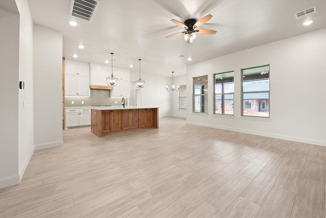 11713 NW 105th St, Yukon, OK 73099 - unfurnished living room featuring a ceiling fan, a sink, a chandelier, recessed lighting, and baseboards