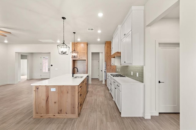 11713 NW 105th St, Yukon, OK 73099 - kitchen featuring light wood-type flooring, tasteful backsplash, light countertops, and recessed lighting