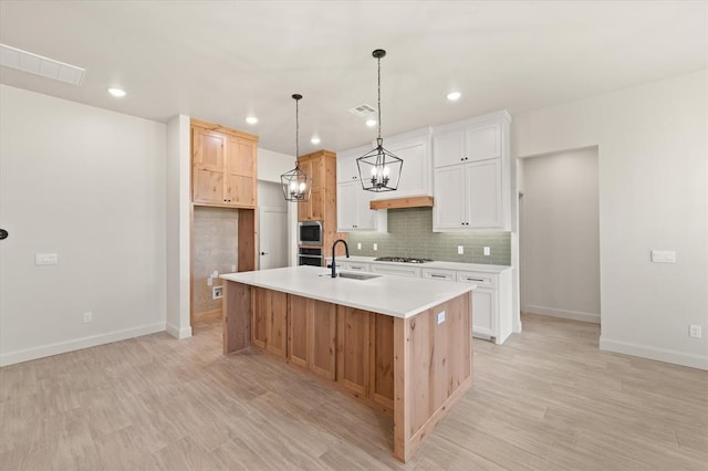 11713 NW 105th St, Yukon, OK 73099 - kitchen featuring appliances with stainless steel finishes, a sink, a chandelier, baseboards, and backsplash