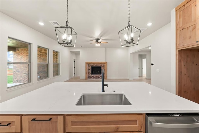 11713 NW 105th St, Yukon, OK 73099 - kitchen with dishwasher, a sink, a chandelier, a brick fireplace, and recessed lighting