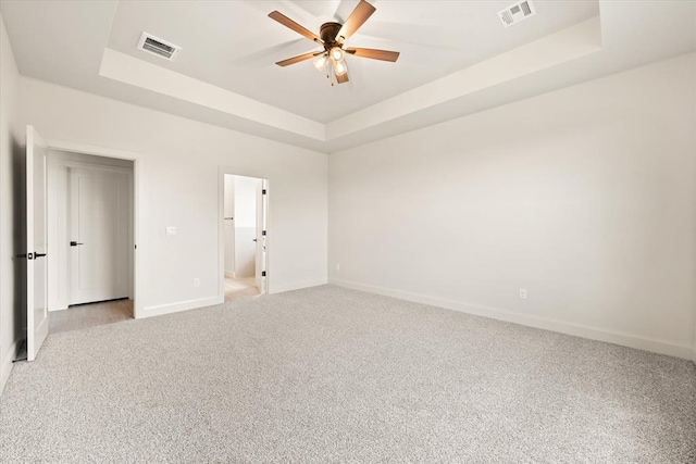 11713 NW 105th St, Yukon, OK 73099 - empty room with light colored carpet, a tray ceiling, baseboards, and a ceiling fan