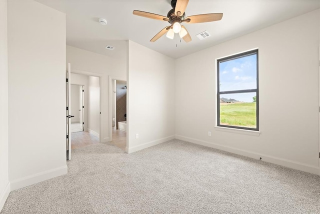 11713 NW 105th St, Yukon, OK 73099 - spare room with light colored carpet, baseboards, a ceiling fan, and a smoke detector