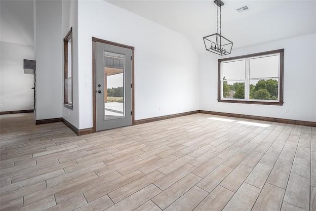 1431 County Road 2977, Blanchard, OK 73010 - spare room with lofted ceiling, a chandelier, and light wood-style flooring