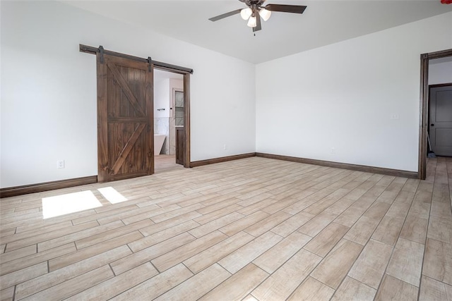 1431 County Road 2977, Blanchard, OK 73010 - empty room with ceiling fan, a barn door, and light wood-style floors