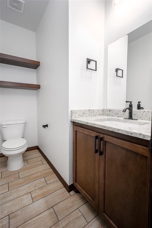 1431 County Road 2977, Blanchard, OK 73010 - half bath featuring vanity and wood finish floors