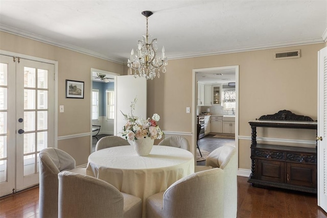 1716 Westminster Pl, Nichols Hills, OK 73120 - dining room featuring french doors, a chandelier, wood finished floors, ceiling fan, and ornamental molding