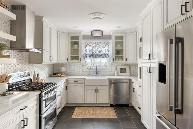 1716 Westminster Pl, Nichols Hills, OK 73120 - kitchen featuring stainless steel appliances, wall chimney exhaust hood, open shelves, light stone countertops, and white cabinetry