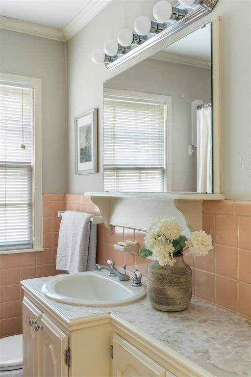 1716 Westminster Pl, Nichols Hills, OK 73120 - bathroom featuring vanity, tile walls, crown molding, and wainscoting