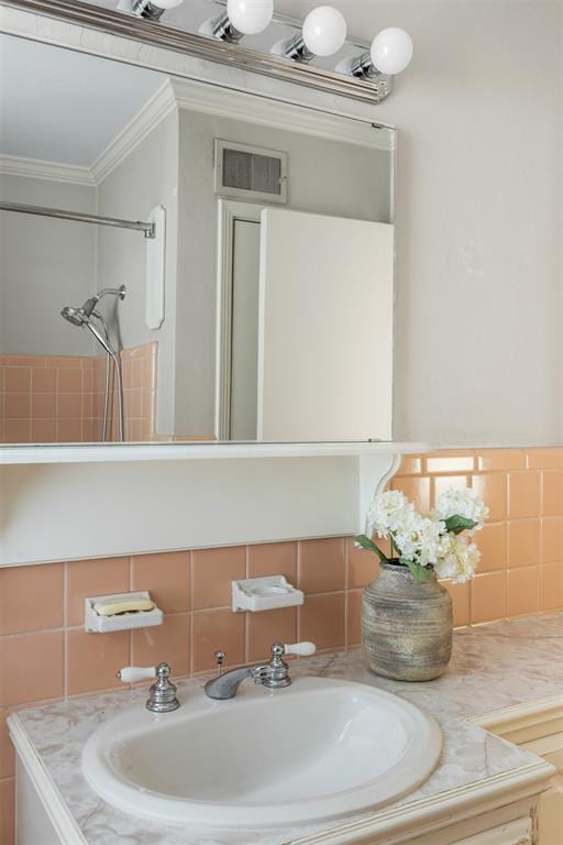 1716 Westminster Pl, Nichols Hills, OK 73120 - bathroom featuring vanity, crown molding, and tile walls