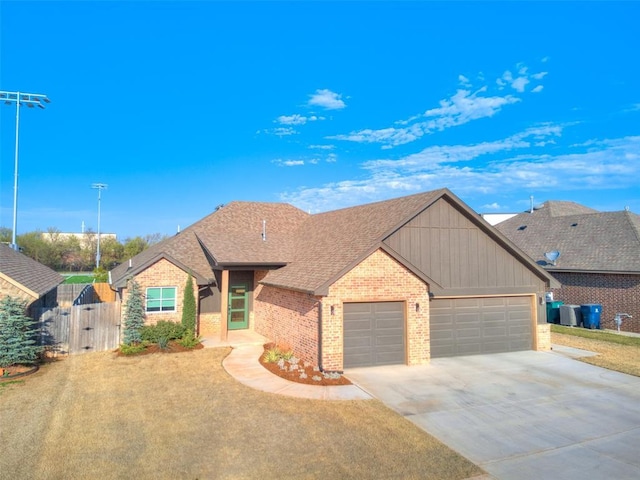 2301 Marjorie Ln, Yukon, OK 73099 - single story home featuring a gate, a garage, brick siding, concrete driveway, and a shingled roof
