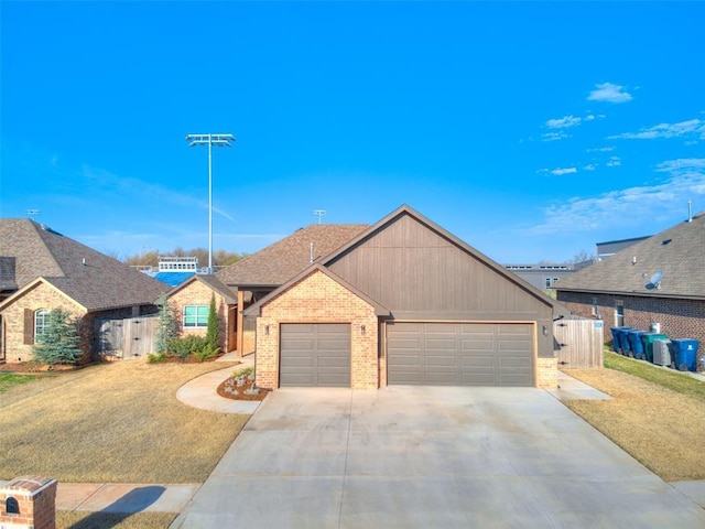 2301 Marjorie Ln, Yukon, OK 73099 - single story home with driveway, a front yard, brick siding, fence, and an attached garage