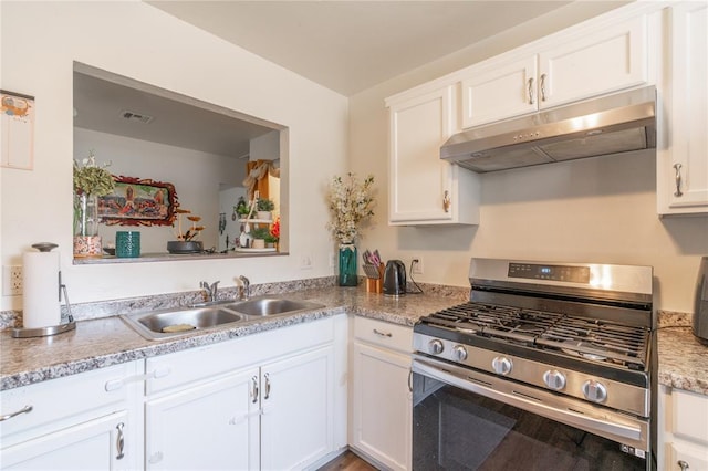 kitchen with under cabinet range hood, a sink, stainless steel gas range, visible vents, and white cabinets