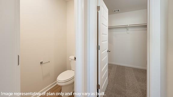 8313 NW 61st St, Oklahoma City, OK 73132 - bathroom with visible vents, baseboards, toilet, and a spacious closet
