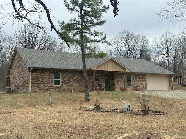114495 S 4296th Rd, Porum, OK 74455 - ranch-style home featuring central air condition unit, driveway, a front yard, a garage, and a shingled roof