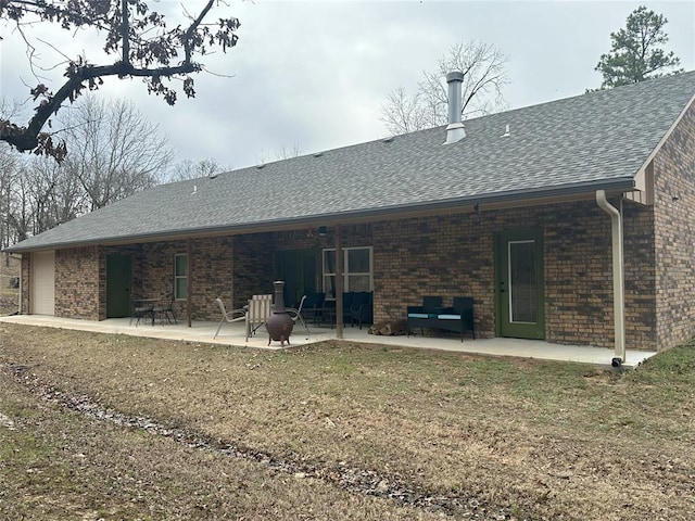 114495 S 4296th Rd, Porum, OK 74455 - rear view of house featuring a patio, brick siding, and roof with shingles