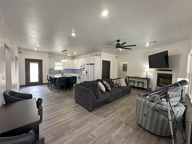 114495 S 4296th Rd, Porum, OK 74455 - living room with recessed lighting, light wood finished floors, visible vents, a ceiling fan, and a fireplace