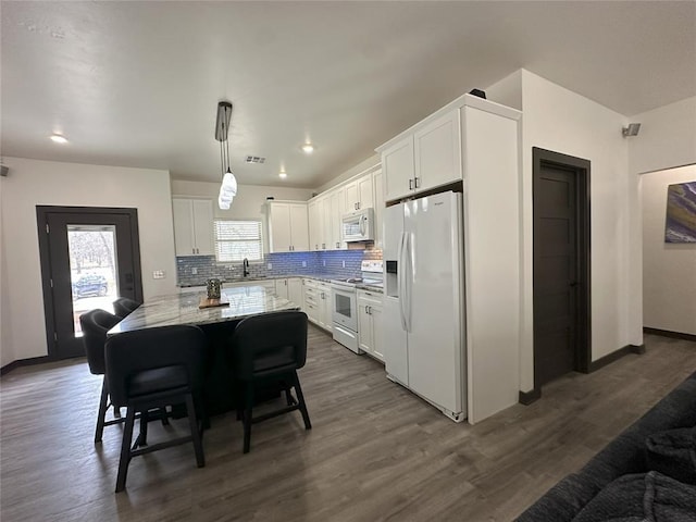114495 S 4296th Rd, Porum, OK 74455 - kitchen with a sink, white cabinetry, dark wood-style floors, white appliances, and decorative backsplash