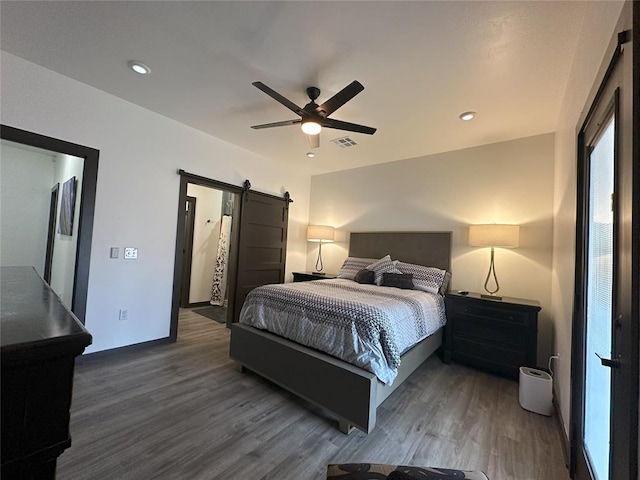 114495 S 4296th Rd, Porum, OK 74455 - bedroom with visible vents, ceiling fan, wood finished floors, recessed lighting, and a barn door