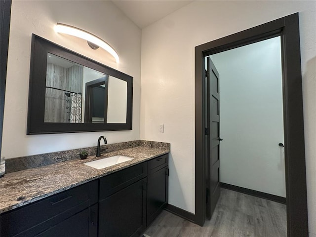 114495 S 4296th Rd, Porum, OK 74455 - bathroom featuring baseboards, wood finished floors, and vanity