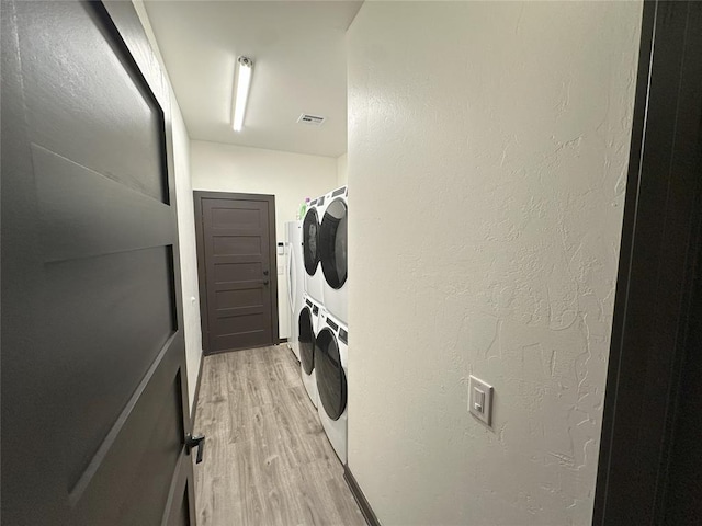 114495 S 4296th Rd, Porum, OK 74455 - washroom featuring stacked washer and dryer, light wood-style flooring, visible vents, and laundry area