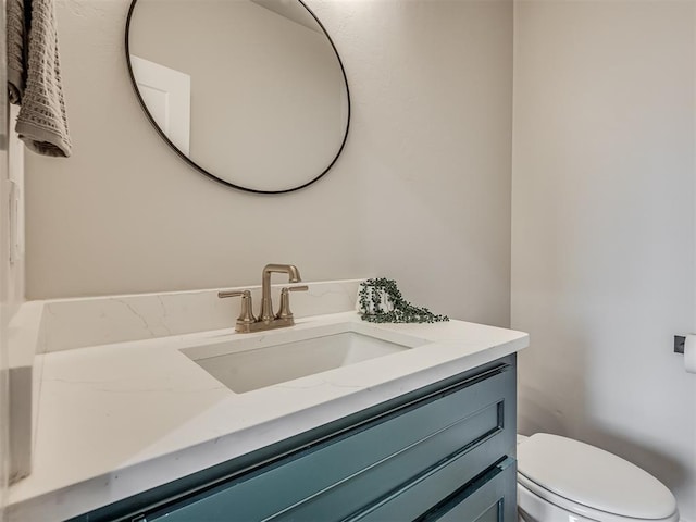 bathroom featuring toilet and vanity